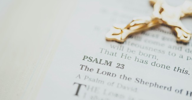 Bible opened to Psalm with a cross