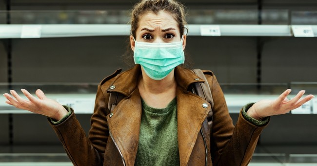 woman angry and upset with coronavirus face mask on