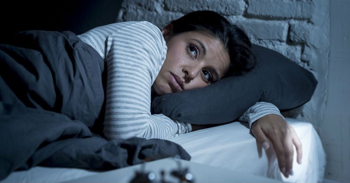 Bible, prayer and black woman praying on bed in bedroom home for