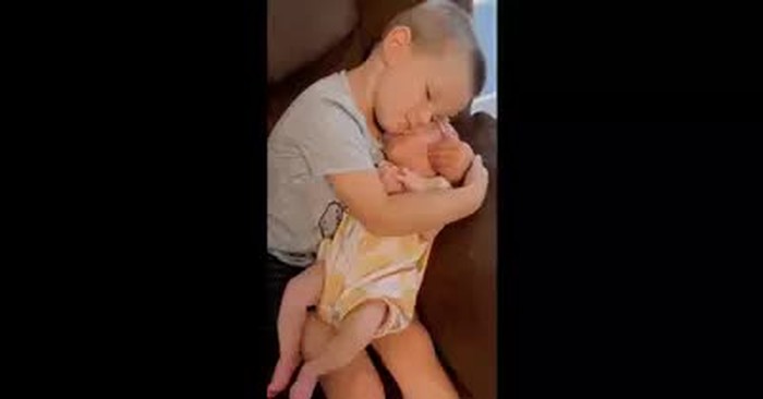 Big Brother Holds Baby Sister And It's A Moment Of Pure Happiness
