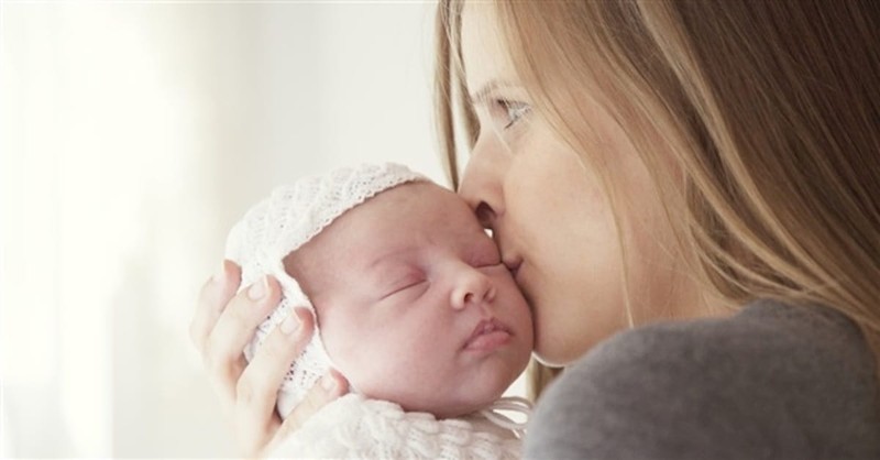 woman kissing baby
