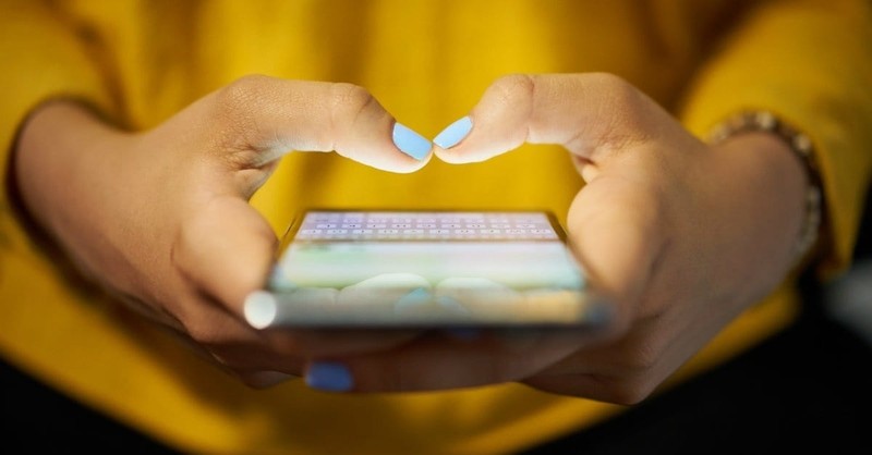 woman holding smart phone in hands