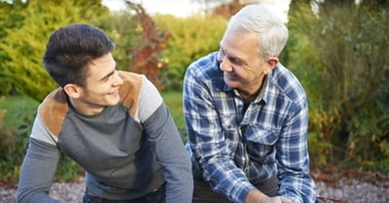 father and son talking and laughing together