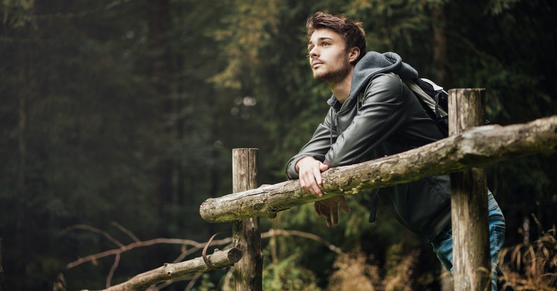 Young man outside looking at nature