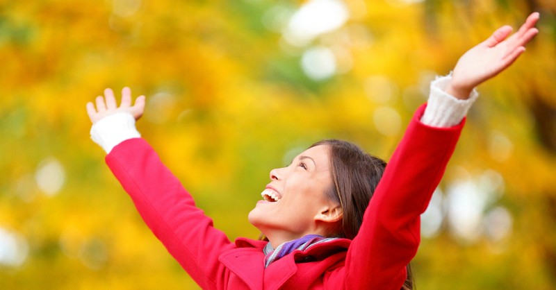 Happy woman with arms raised in joy