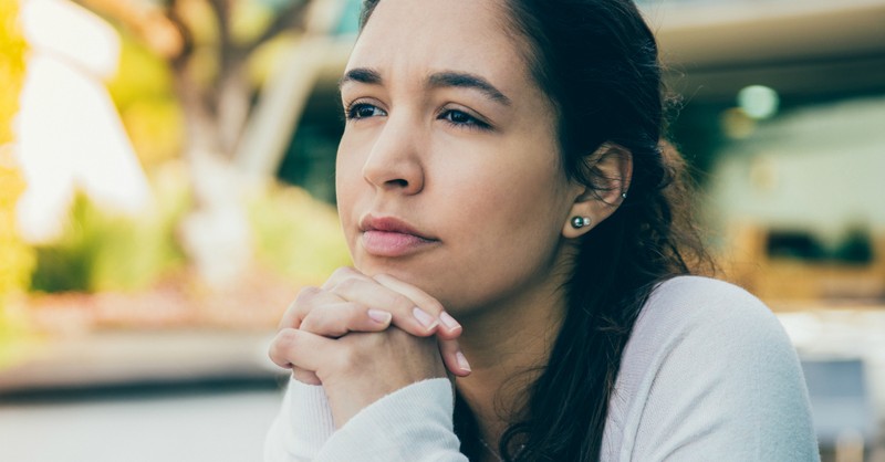 young woman looking wistfully into the distance