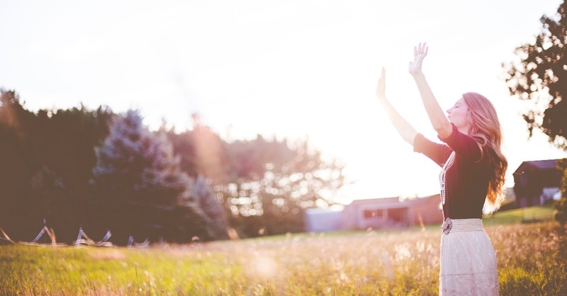 woman worshipping god in a field, god is great