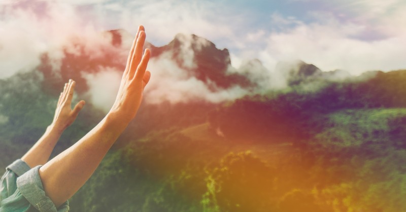 Hands raised in worship outside; the first and second commandments.