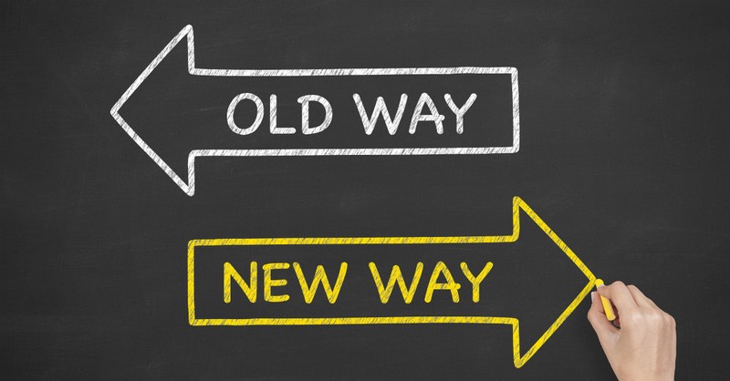 "old way" and "new way" signs pointing in opposite directions