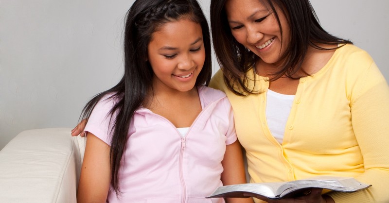 Mother and daughter reading the Bible together
