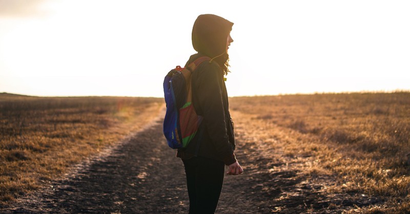 girl on path at sunset, songs to listen to when life is changing