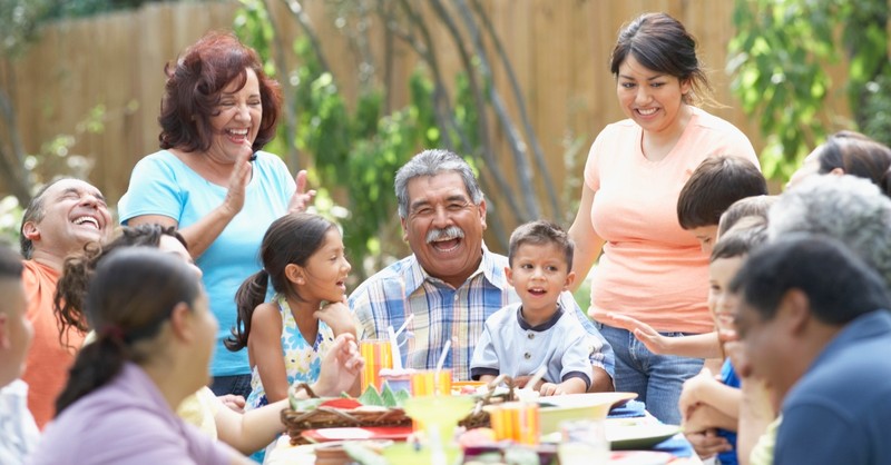 Big family enjoying dinner together, fear harm children's faith