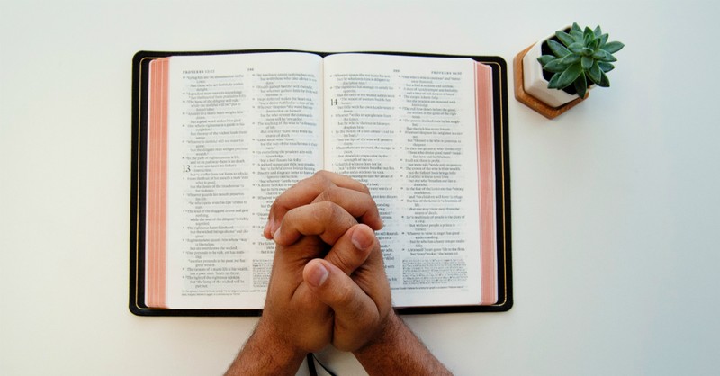 praying hands on open bible, give thanks to the lord