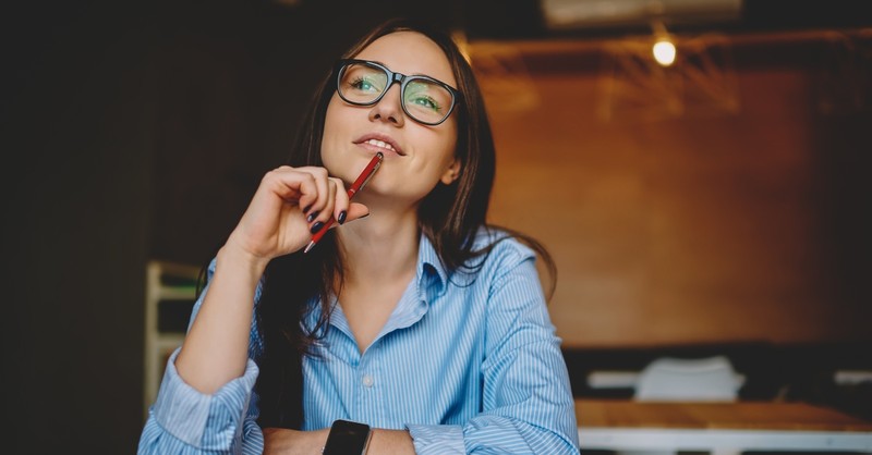 Young woman thinking while working