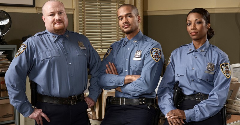 three police officers in uniform in office