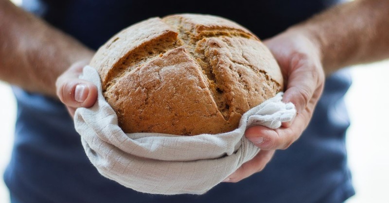 hand holding baked bread, holy week reading plan