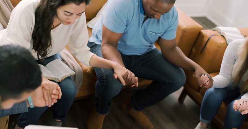 small group holding hands in prayer Bible study, uncomfortable talking about race