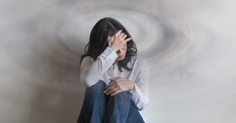 A sad woman sitting on the floor