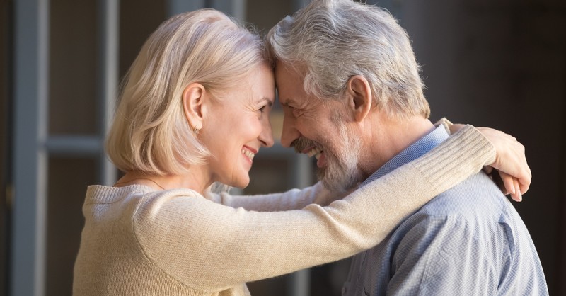 senior couple eye to eye foreheads together smiling