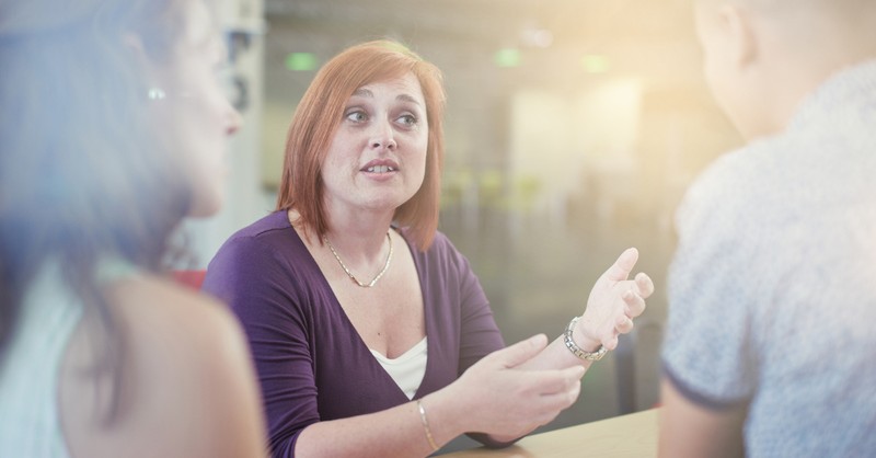 woman talking to others in a serious conversation