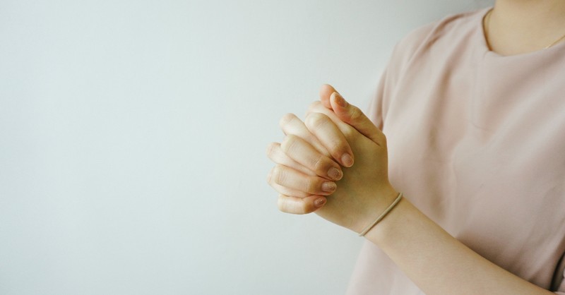 Woman in a bright light praying