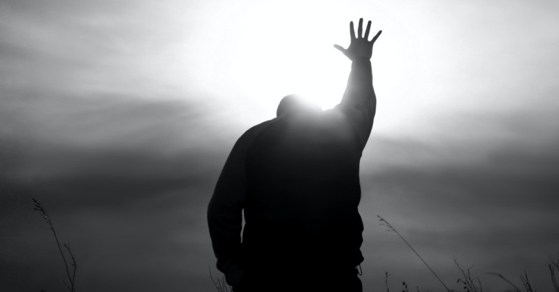 A man with his hands in the air in praise, Man of God