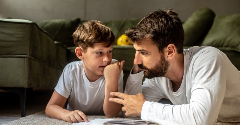 son and dad reading having a conversation