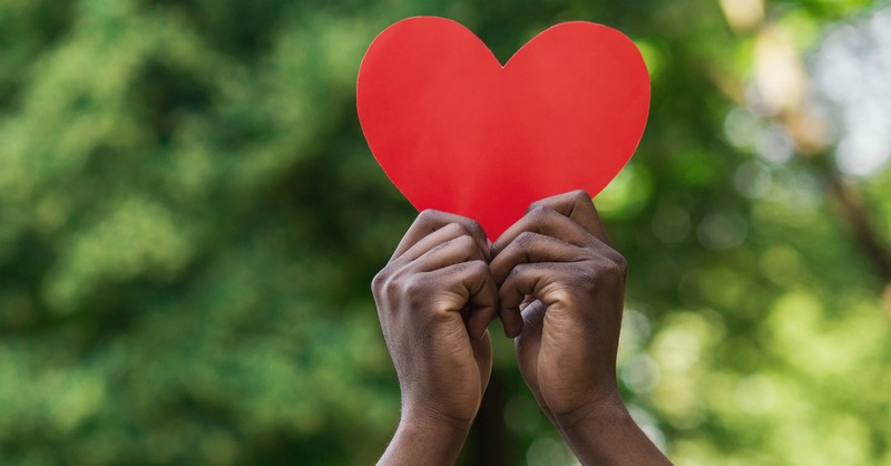 kids hands holding up heart