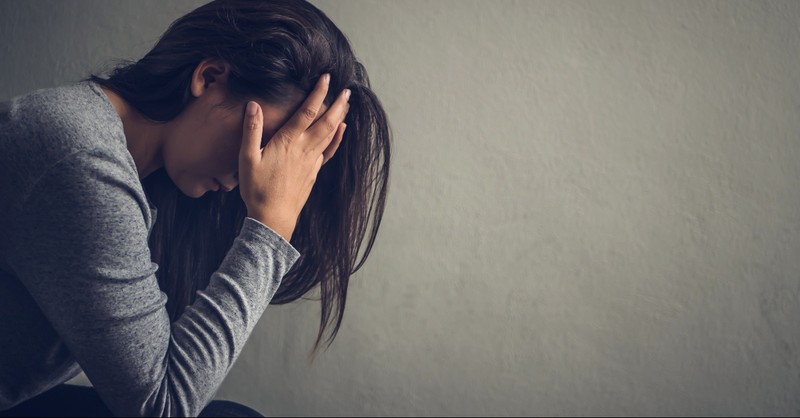 Woman crying into her hands