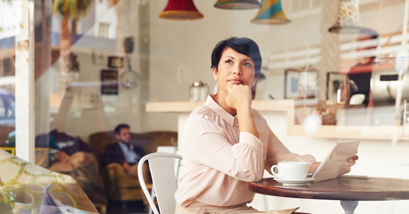 mature woman thinking in coffee shop