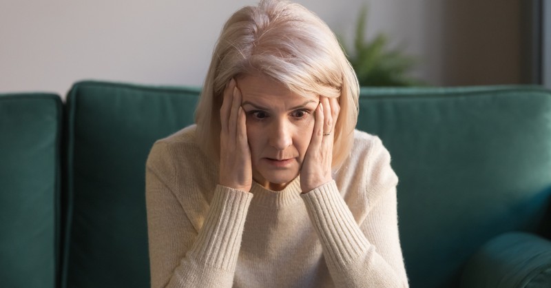 senior mature woman upset and stressed looking at laptop