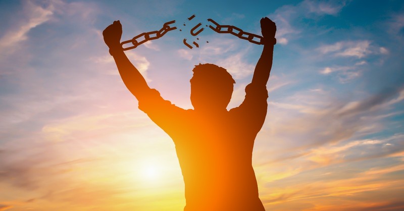 silhouette of man breaking free from chain