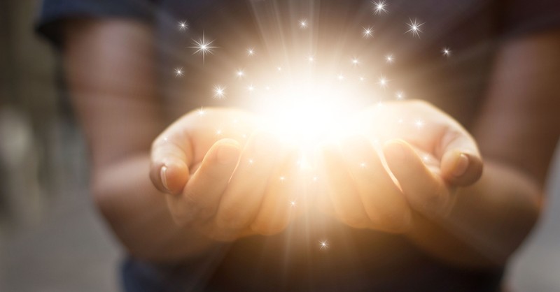 hands open with glowing stars to signify giving generously