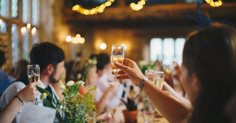 Guests raising a glass for a wedding toast