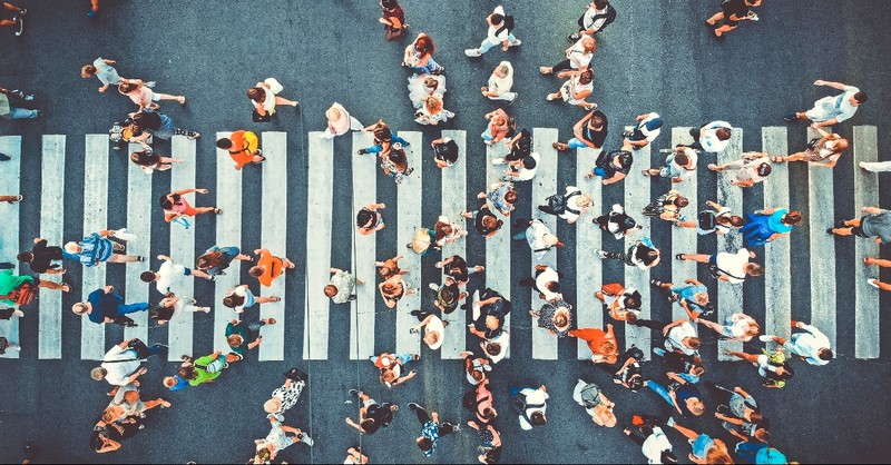 People walking a crosswalk from aerial view