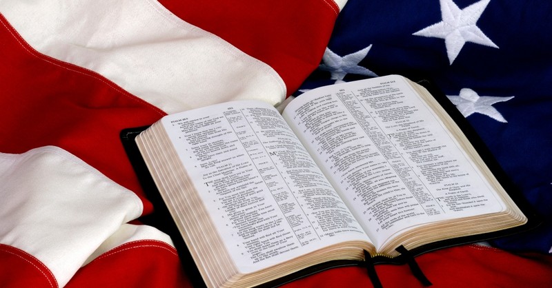 Open Bible on top of an American flag