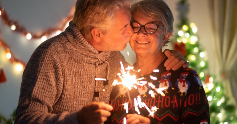 Elderly couple kissing at Christmas