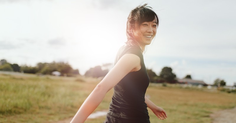 woman walking outside looking happy