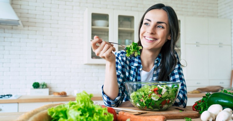 Vegetarian woman eating a salad