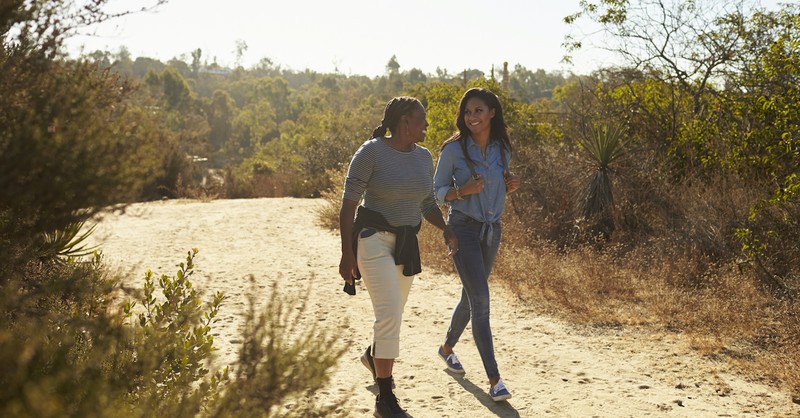 mother and daughter walking outside on hike