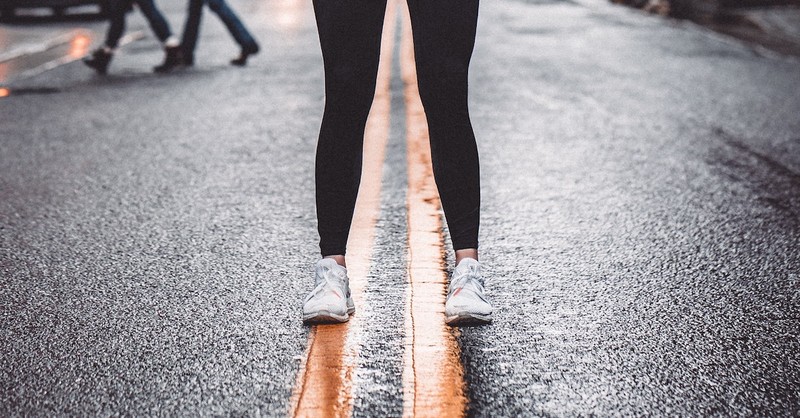 person in yoga pants from the knee down on city street