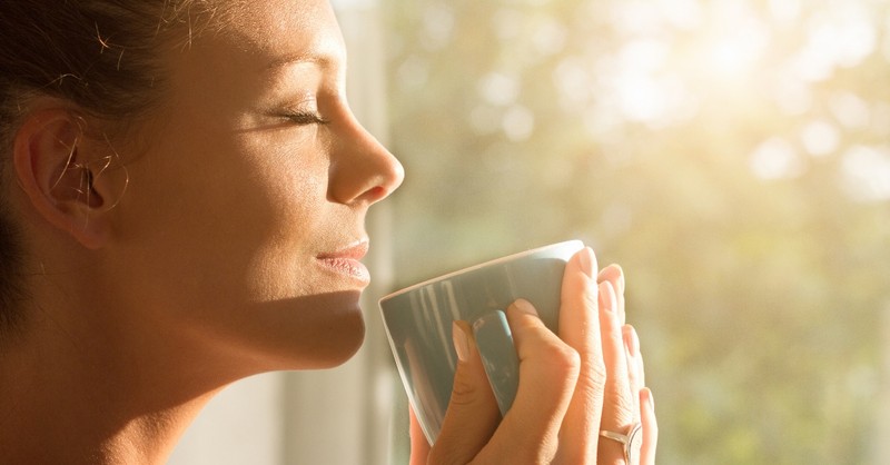 woman drinking morning cup looking peaceful
