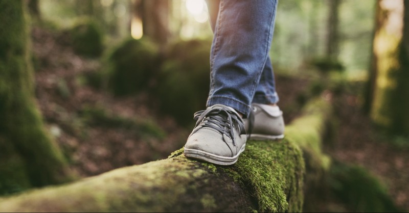 A woman walking on a log