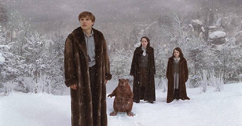The four siblings in Narnia standing in the snow