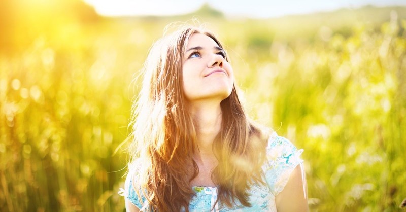woman smiling in field, hebrews 11 faith believes gods promises