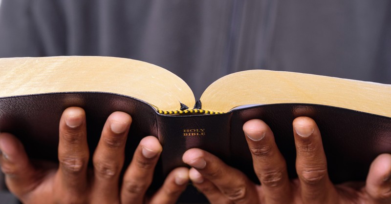 a man holding a Bible