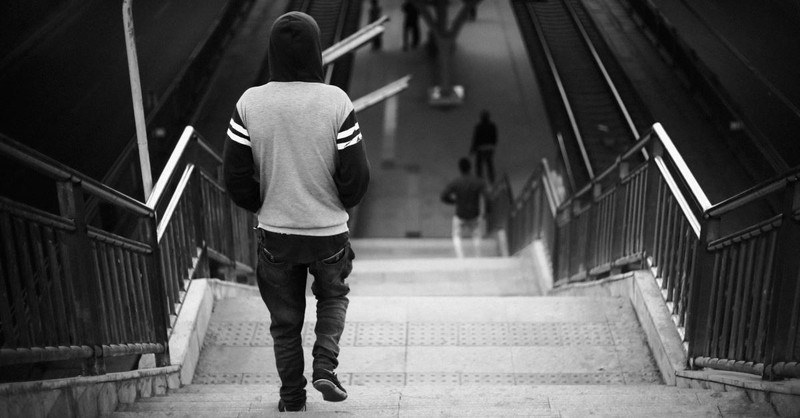 steps man walking down city staircase