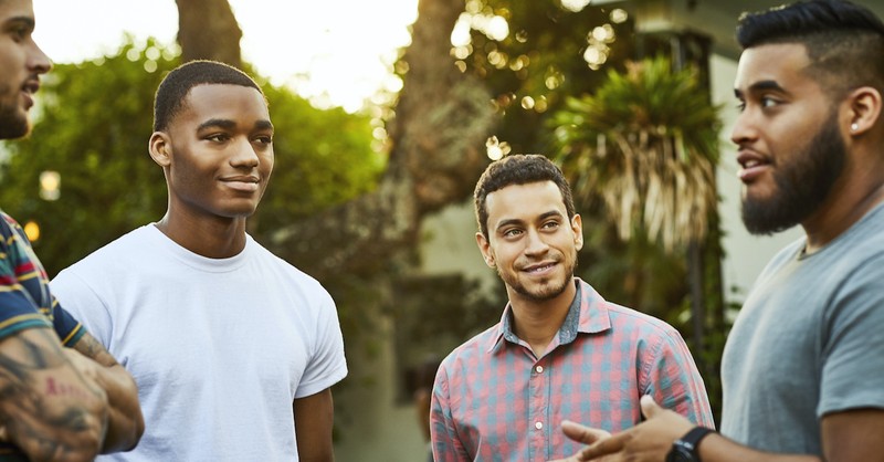 group of men talking outside