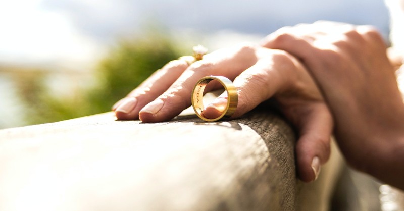 hands holding wedding ring