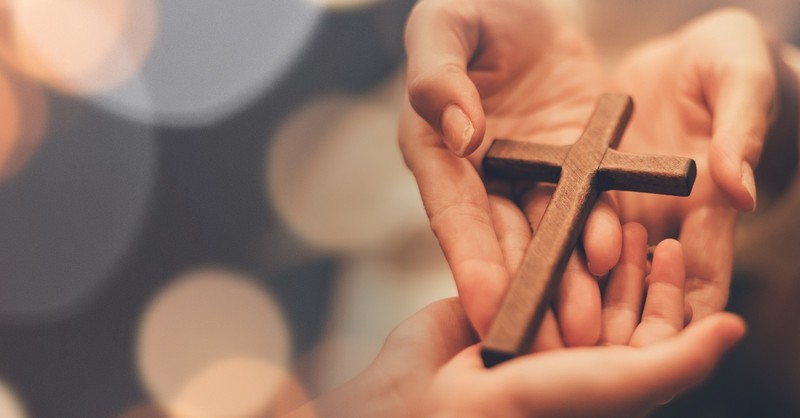 hands holding out cross to smaller hands, how to leave a legacy of faith
